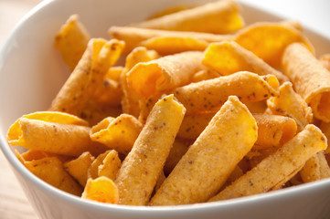 cheese potato chips in a white bowl