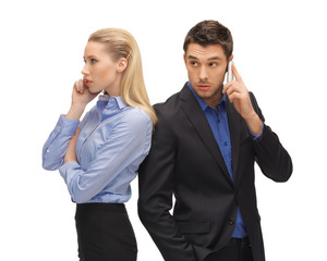 man and woman with cell phones