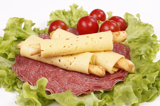 Salty cheese crackers with salami and tomatoes