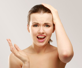 Young woman with head pain on white background