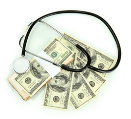 Healthcare cost concept: stethoscope and dollars isolated