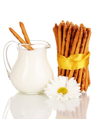 Tasty crispy sticks with pitcher with sour cream isolated