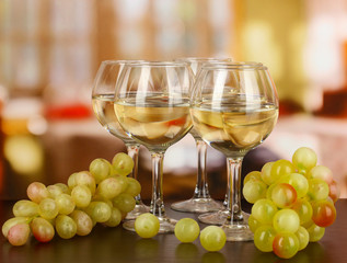 White wine in glass on room background