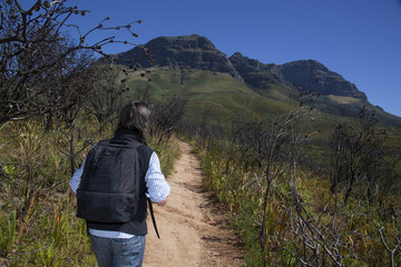A man walikng up a mountain