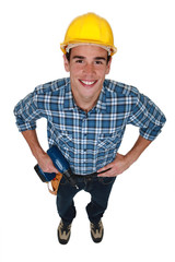 Young tradesman holding a power tool