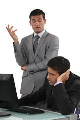 Arrogant businessman talking to his colleague
