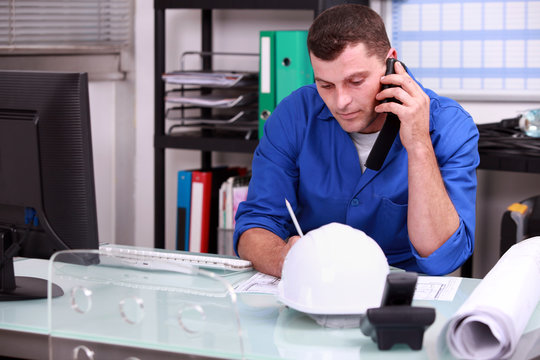 Construction Foreman Speaking On The Phone