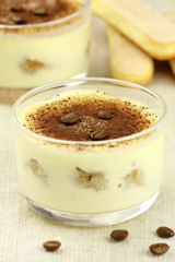 Italian dessert Tiramisu in glass cups with coffee beans