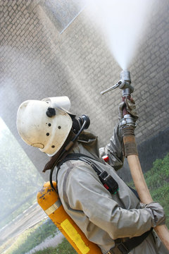 Fireman spraying water