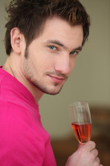 Young man drinking wine
