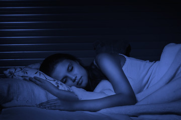 Fototapeta na wymiar Sensual girl sleeping in the bedroom