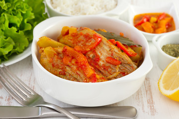 fish stew in the white bowl and salad