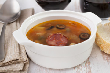 soup with chorizo in the white bowl