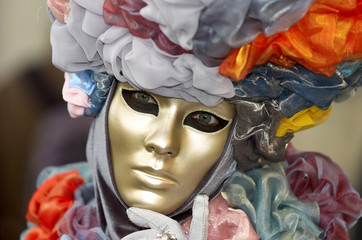 Person in Venetian costume attends Carnival of Venice.