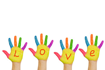The word "love" written in paints on colorful hands.