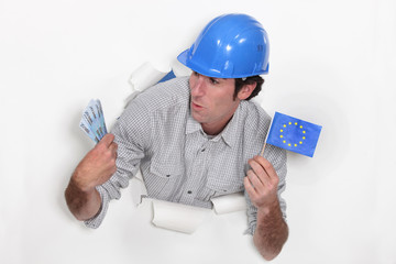 Tradesman holding a European Union flag and money