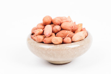 Peanuts in bowl on white