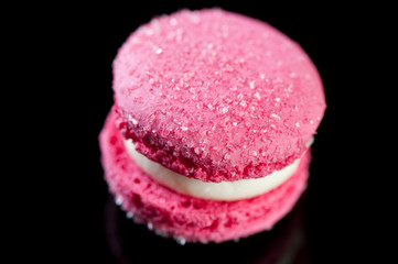 Close-up of a french macaroon against black background