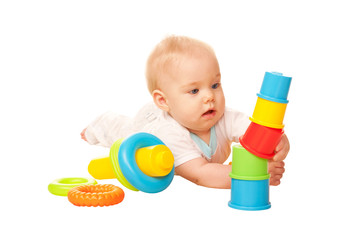 Baby building tower of colorful blocks.