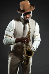 Black american jazz saxophone player. Vintage. Studio shot.