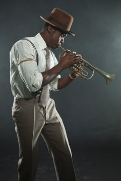 Black american jazz trumpet player. Vintage. Studio shot.