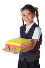 Smiling girl standing with stack of books