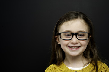 Smart young girl stood infront of a blackboard