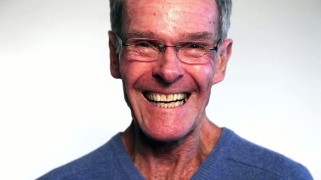 Smiling senior man wearing glasses against white. Studio shot..