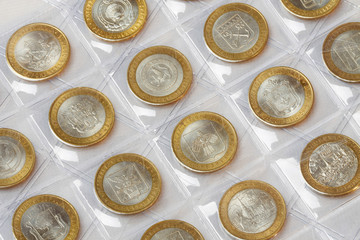 Collection of anniversary coins rubles in a klyasser on a white