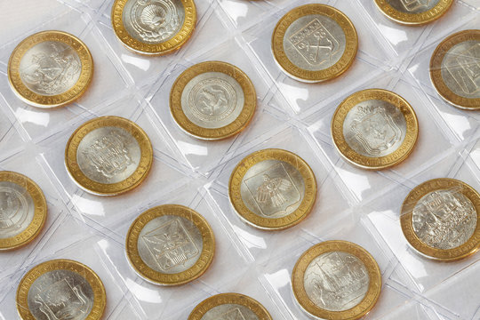 Collection of anniversary coins rubles in a klyasser on a white