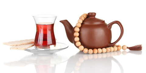 glass of Turkish tea and kettle isolated on white