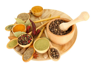 wooden mortar, bowls and spoons with spices isolated on white