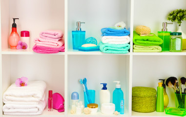 Bath accessories on shelfs in bathroom