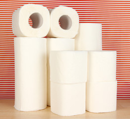 Rolls of toilet paper on striped red background