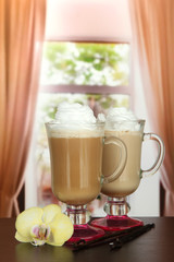 Fragrant coffee latte in glasses cups with vanilla pods,