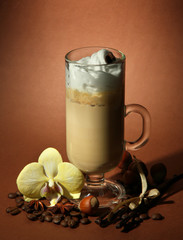 Fragrant coffee latte in glass cup with spices,