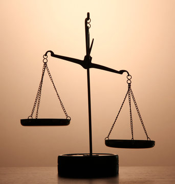 Gold Scales Of Justice On Brown Background