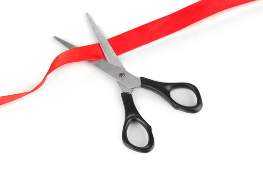 Cutting red ribbon isolated on white