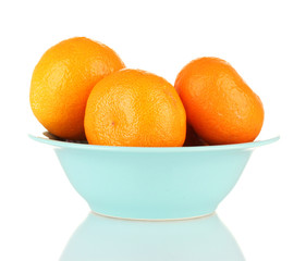 Tasty mandarines in color bowl isolated on white
