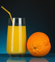 Delicious orange juice in glass and orange next to it
