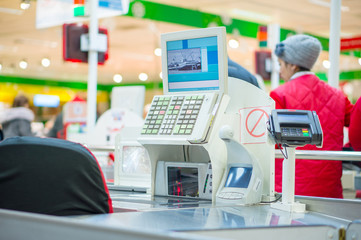 Empty cash desk with terminal in supermarket