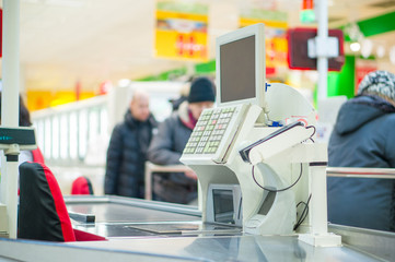 Empty cash desk with terminal in supermarket