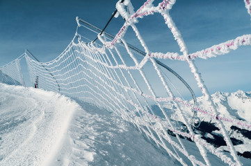 Safety net on ski run in italian alps
