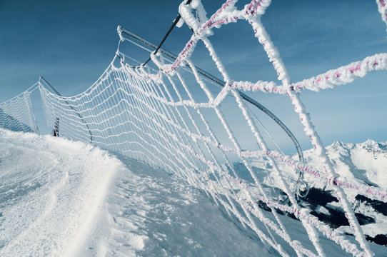 Safety net on ski run in italian alps