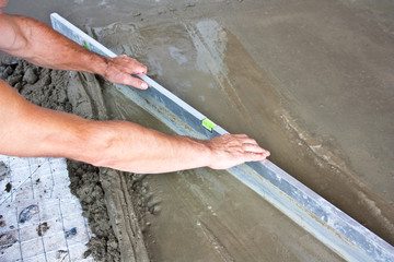 Plasterer concrete worker at floor work