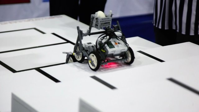 Referee watch toy robot climbs on stairs