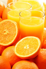Composition with two glasses of orange juice and fruits