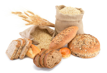 Assortment of baked bread over sack of wheat
