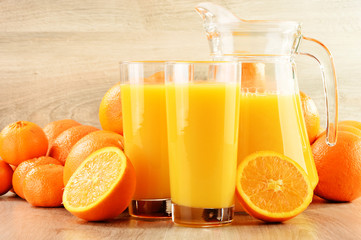Naklejka na ściany i meble Composition with two glasses of orange juice and fruits