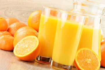 Composition with two glasses of orange juice and fruits